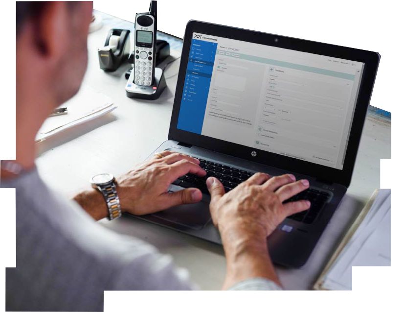 A man typing on a laptop with ConnectWise software on the screen